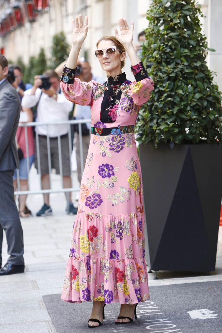 Celine Dion poses under a pedestrian underpass in a pyjama suit in Paris