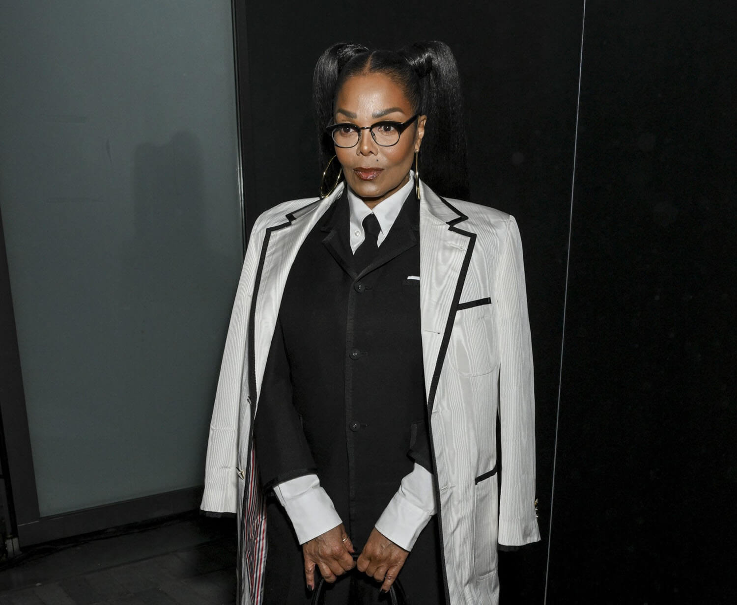 A rarely seen Janet Jackson steps out in pigtails for the Thom Browne ...