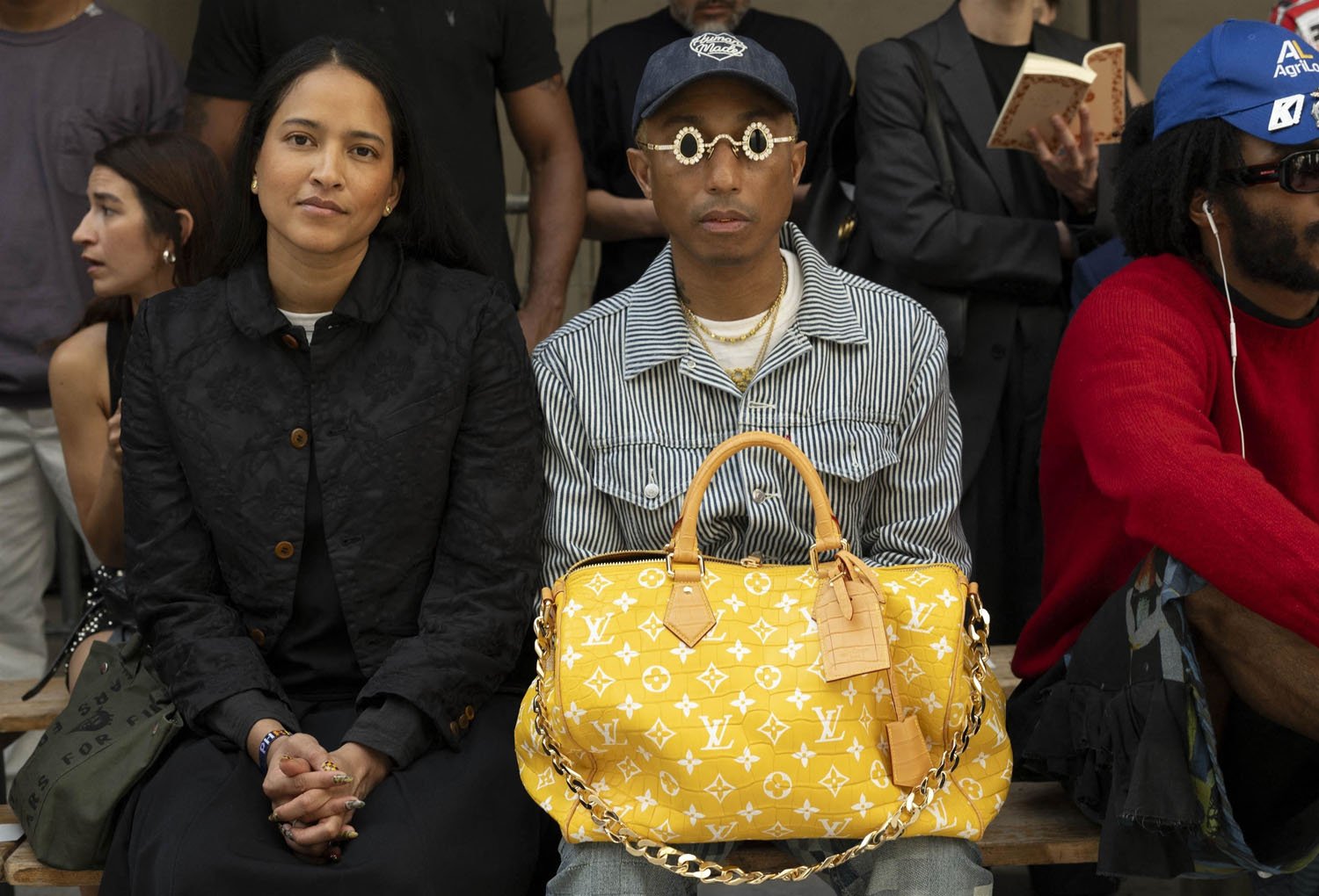Pharrell Williams takes a victory lap at the Loewe show in Paris,  accessorising with his Millionaire bag