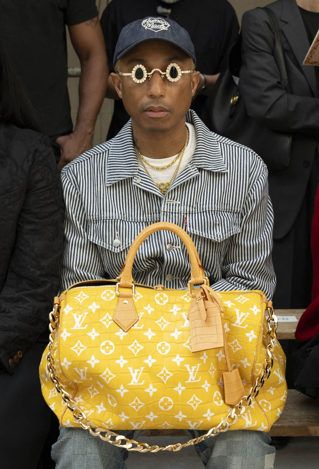 Pharrell Williams takes a victory lap at the Loewe show in Paris,  accessorising with his Millionaire bag