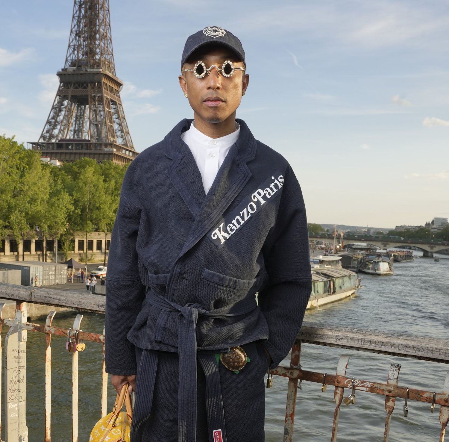 Pharrell Williams takes a victory lap at the Loewe show in Paris,  accessorising with his Millionaire bag