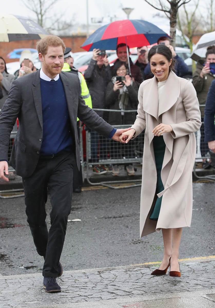 Prince Harry and Meghan Markle hold hands at the saloon in Northern Ireland