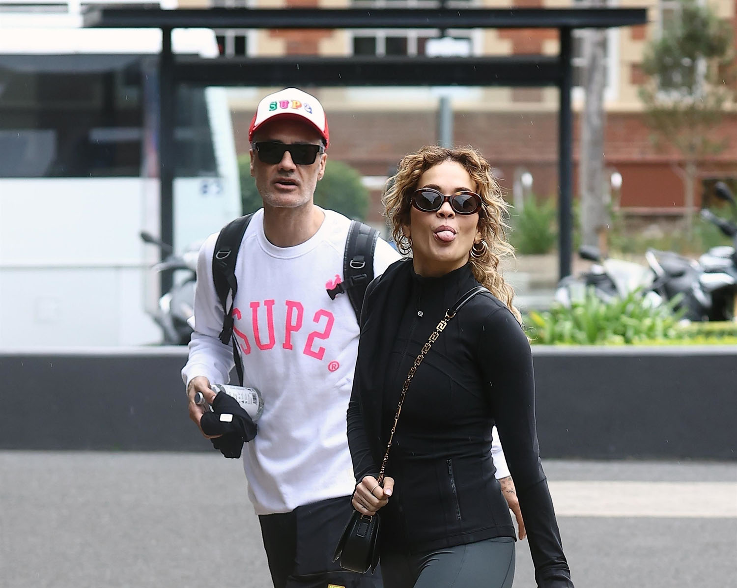 Fun couple Taika Waititi and Rita Ora mug for the cameras in Sydney as