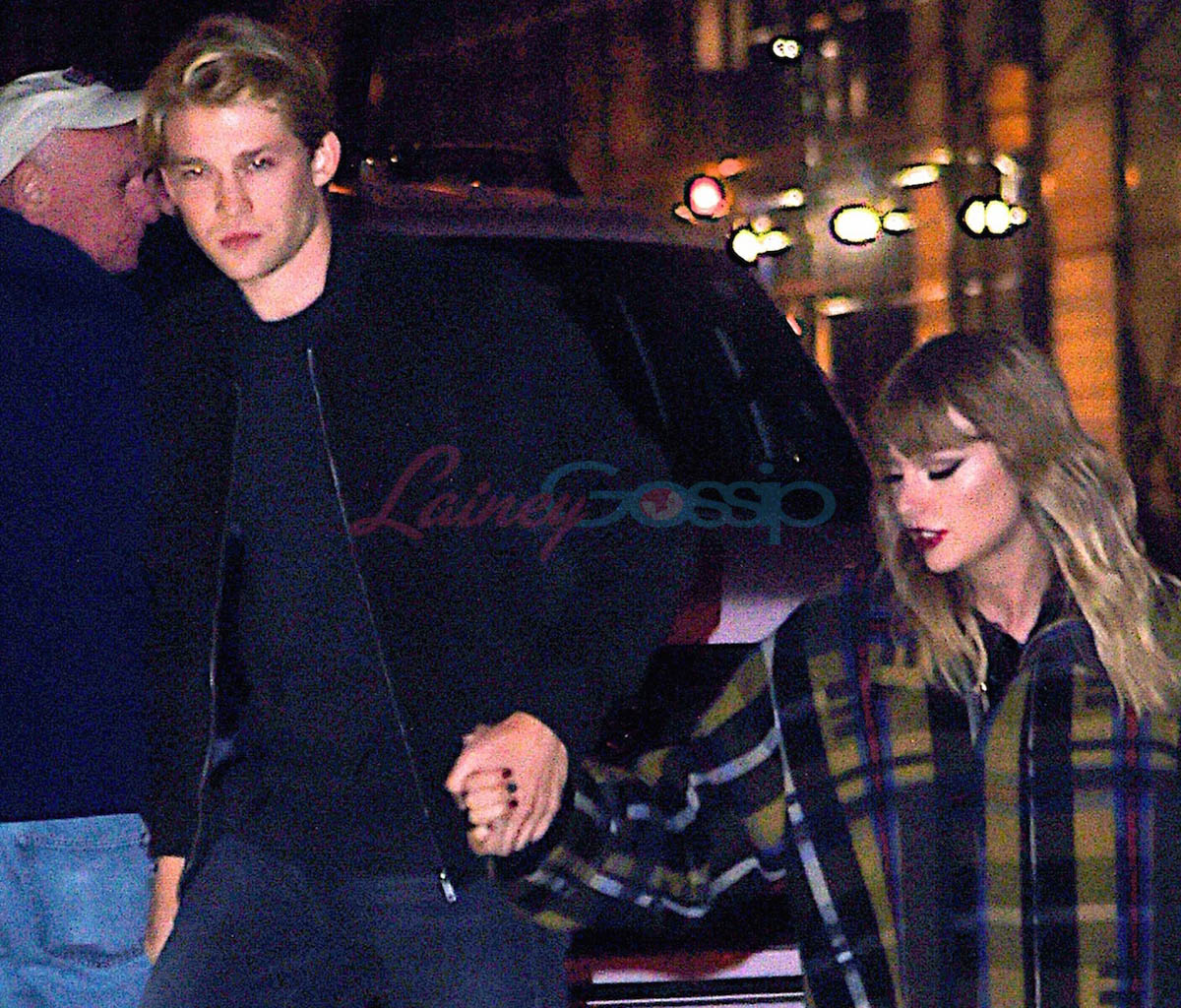Joe Alwyn watches Taylor Swift perform and is photographed holding hands