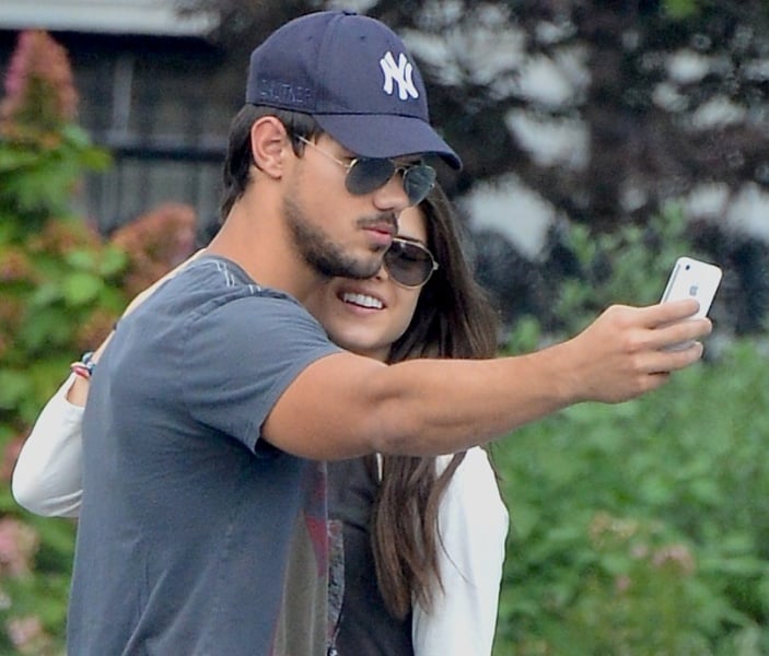 taylor lautner and marie avgeropoulos holding hands