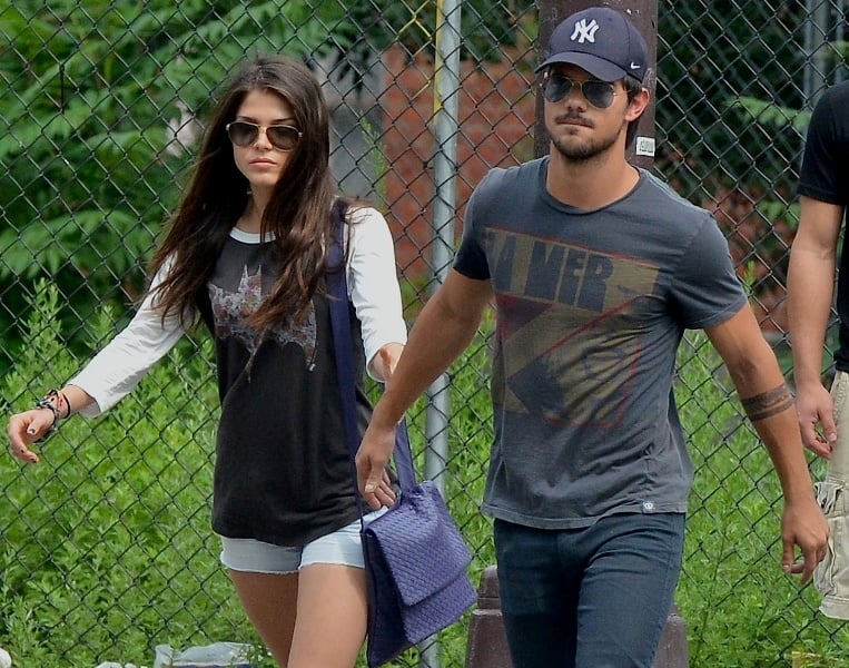 taylor lautner and marie avgeropoulos holding hands