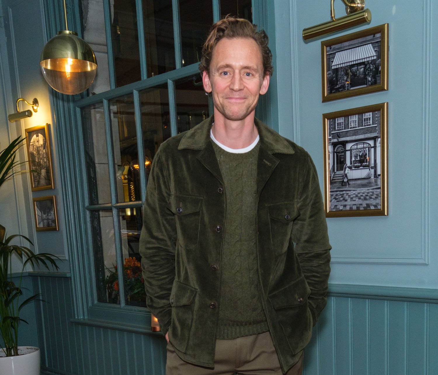 Tom Hiddleston dressed in green like he could have been hanging out