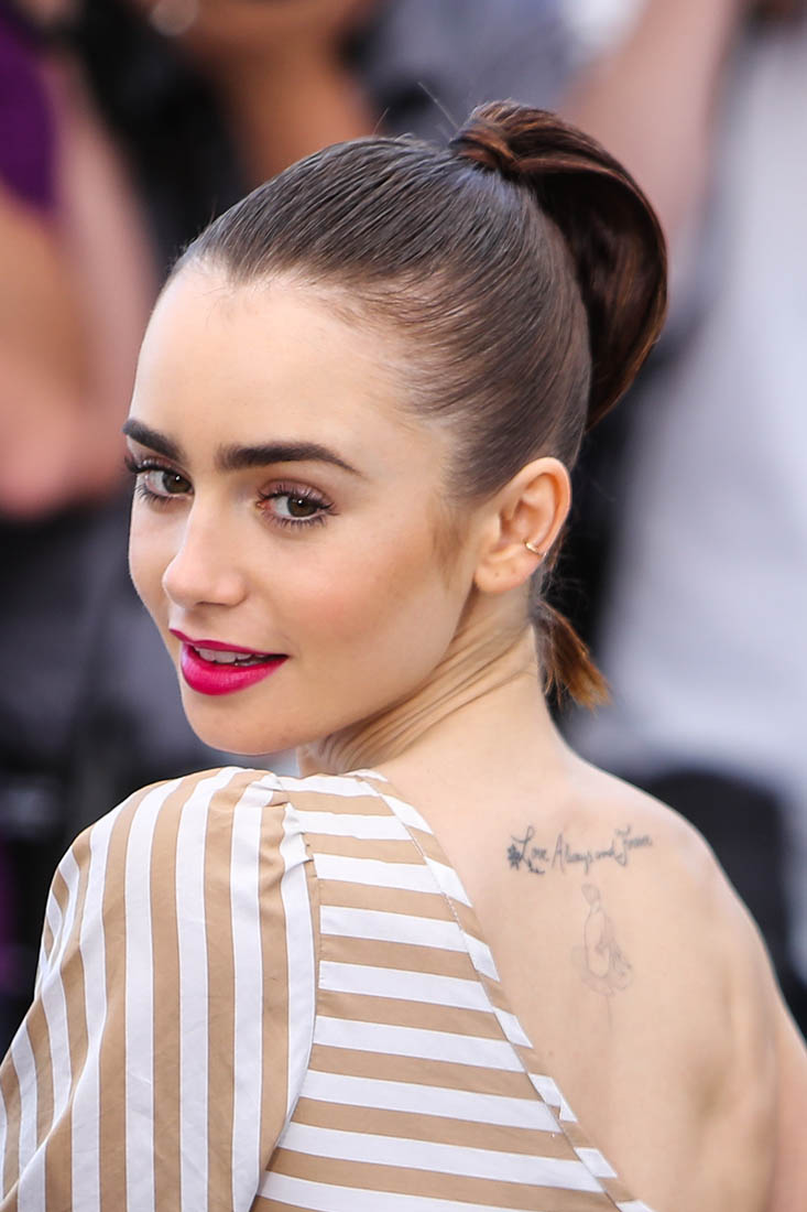 Lily Collins sports a Croydon face lift bun to watch Moss on the